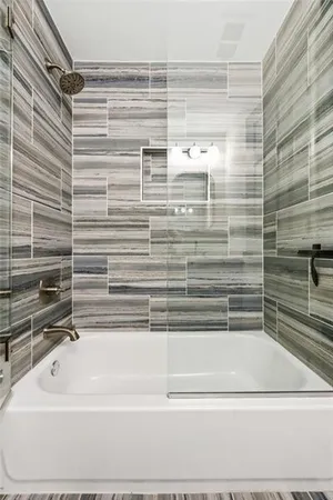 a bathroom with a bathtub and a shower