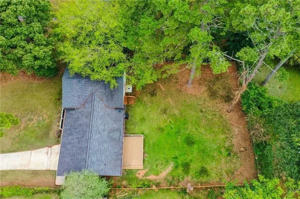 an aerial view of a house with a yard