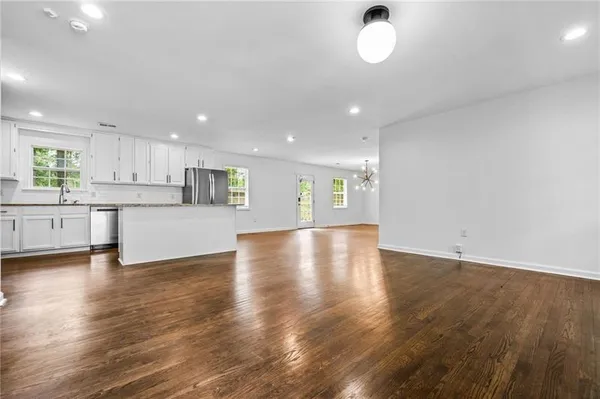 a view of kitchen with wooden floor and window