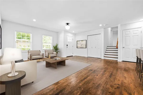 a living room with furniture and a wooden floor