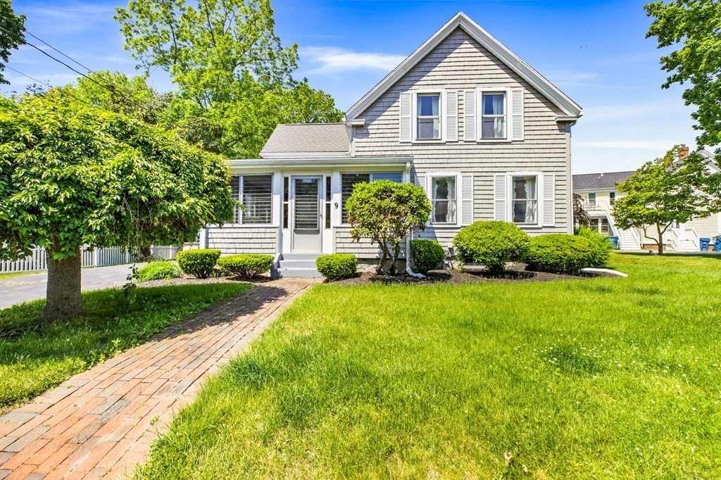 a front view of a house with a yard and porch