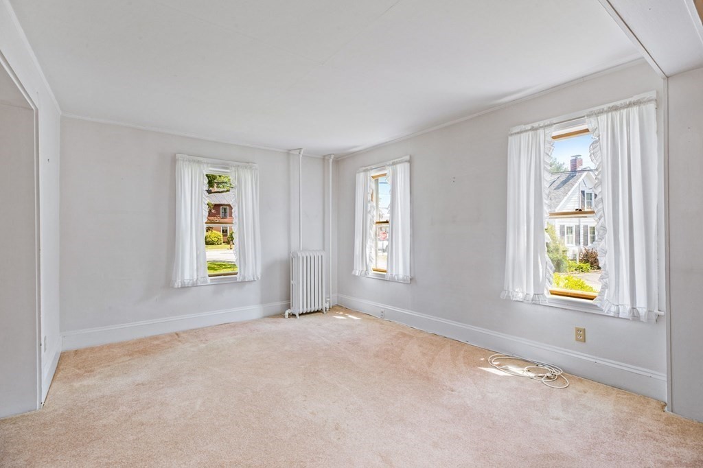 9 Messinger Street Canton, MA 02021 - Photo 15 of 31 an empty room with window and wooden floor
