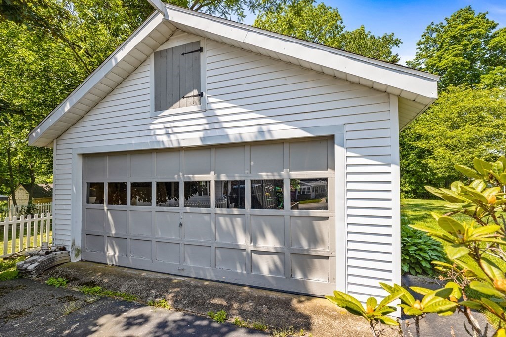 9 Messinger Street Canton, MA 02021 - Photo 2 of 31 a view of a white house with large windows and potted plants