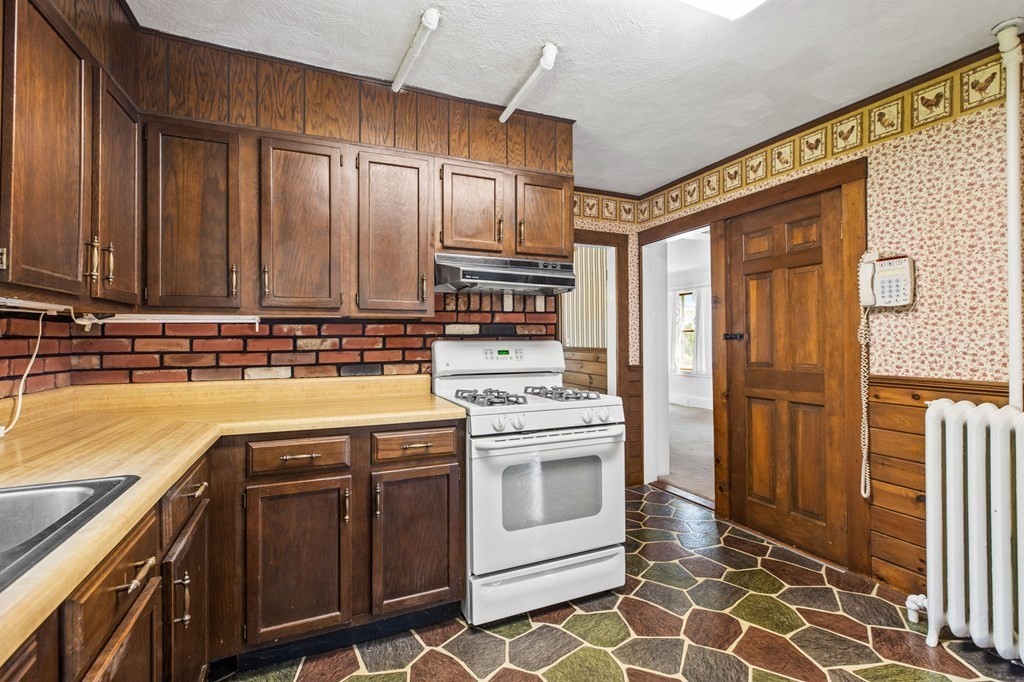 9 Messinger Street Canton, MA 02021 - Photo 4 of 31 a kitchen with stainless steel appliances granite countertop a stove a sink and a refrigerator