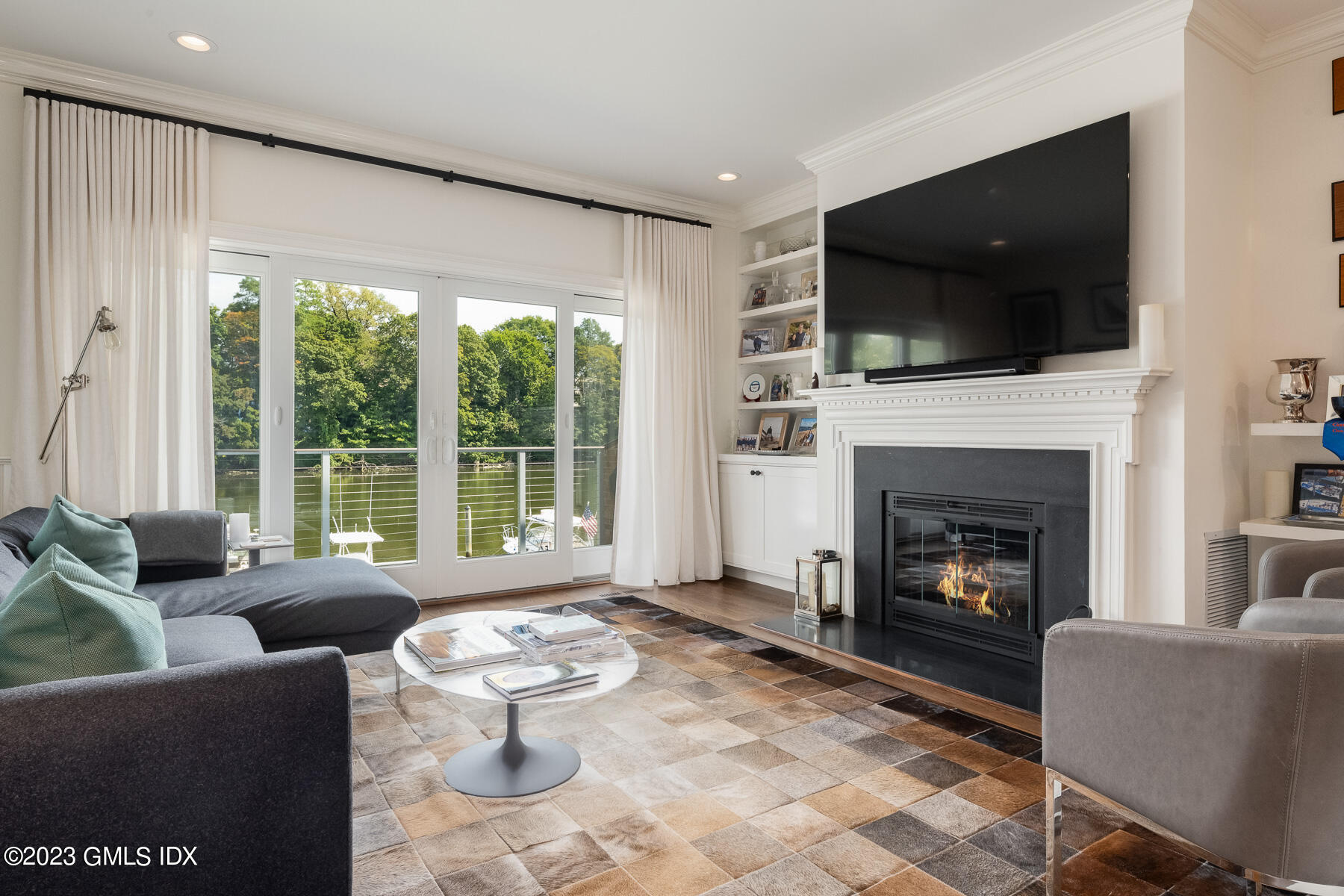 115 River Road, Unit 12 Cos Cob, CT 06807 - Photo 11 of 27 a living room with furniture a flat screen tv and a fireplace