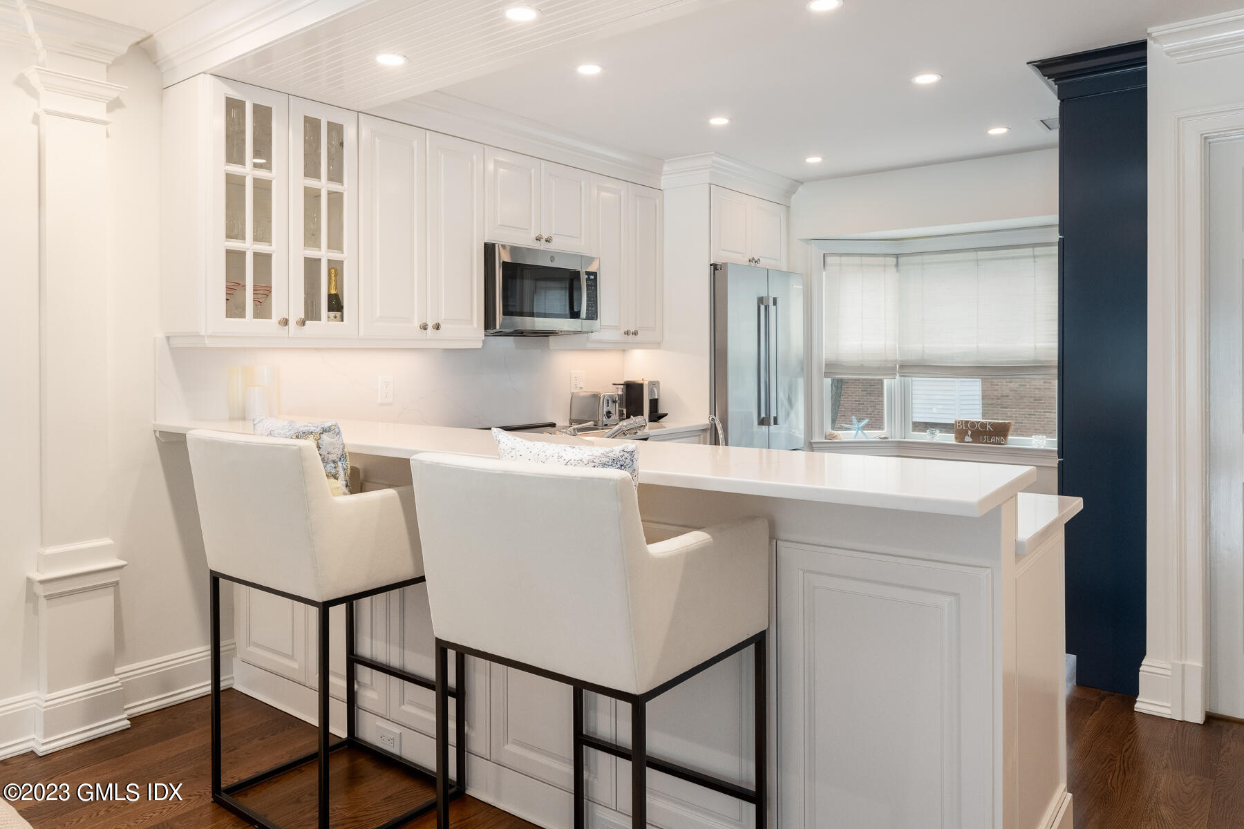 115 River Road, Unit 12 Cos Cob, CT 06807 - Photo 14 of 27 a kitchen with kitchen island white cabinets and refrigerator