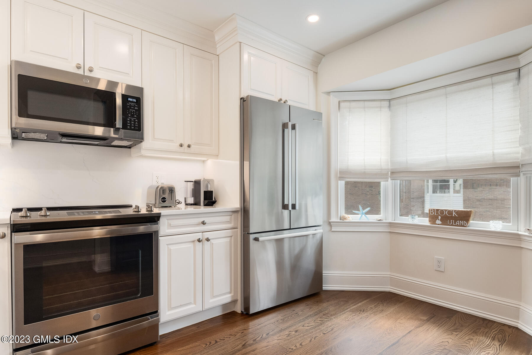 115 River Road, Unit 12 Cos Cob, CT 06807 - Photo 15 of 27 a kitchen with stainless steel appliances a stove microwave and sink