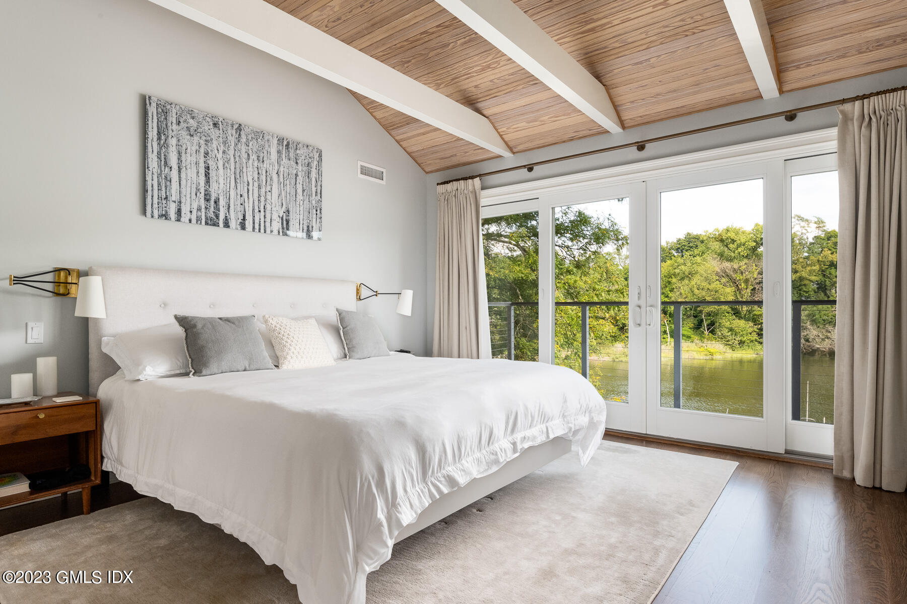 115 River Road, Unit 12 Cos Cob, CT 06807 - Photo 17 of 27 a bedroom with a large bed and a large window