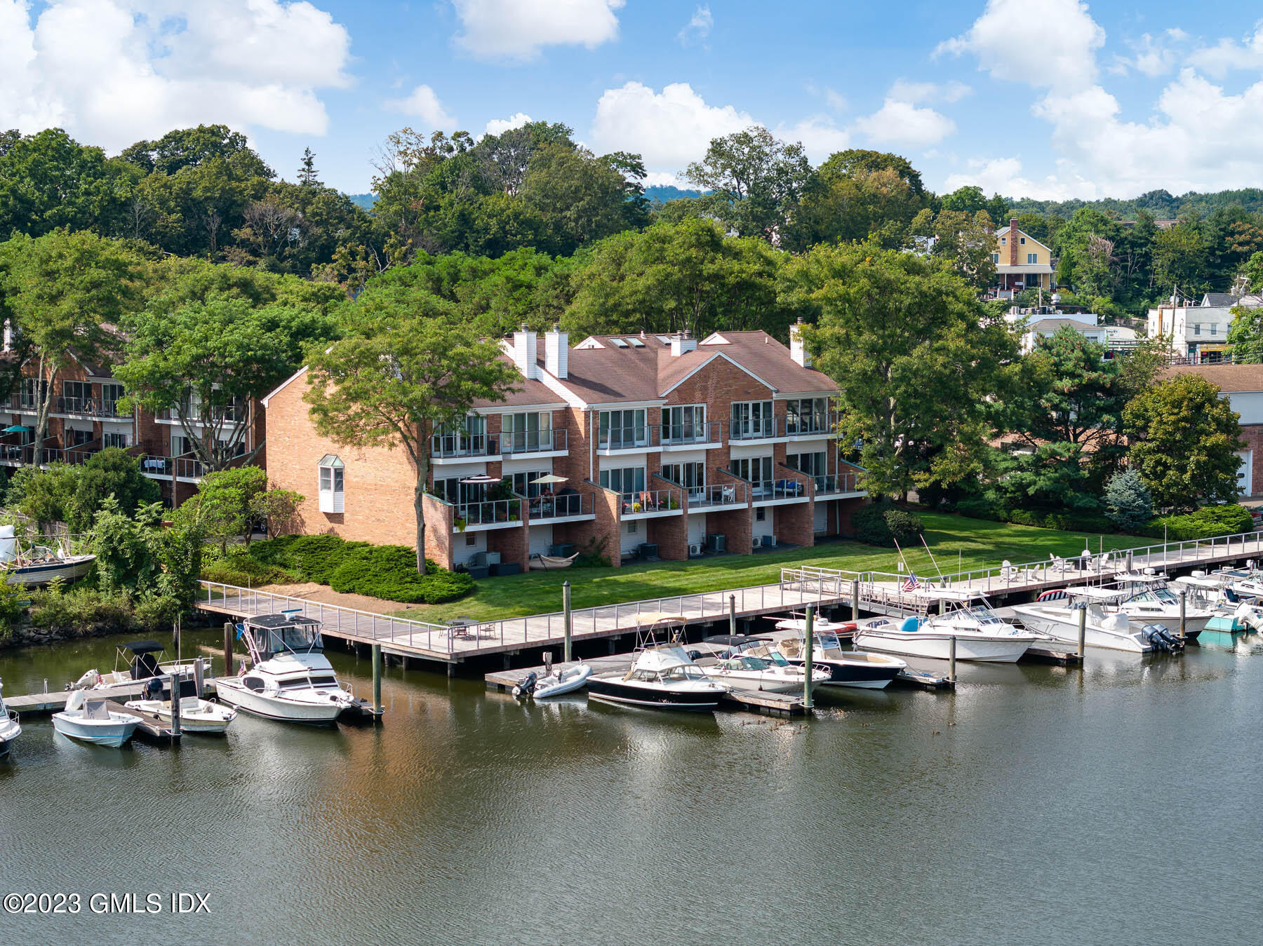 115 River Road, Unit 12 Cos Cob, CT 06807 - Photo 2 of 27 a view of swimming pool with outdoor seating and lake view