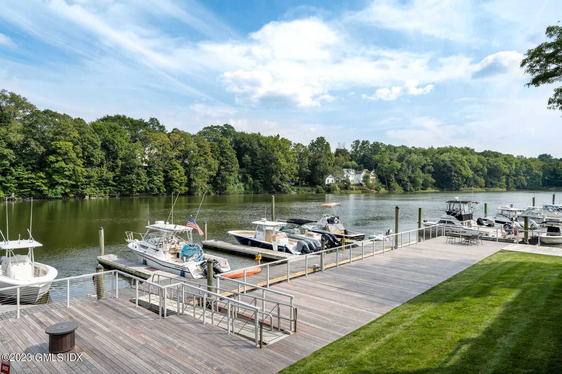 115 River Road, Unit 12 Cos Cob, CT 06807 - Photo 8 of 27 a view of a lake with lawn chairs and a table