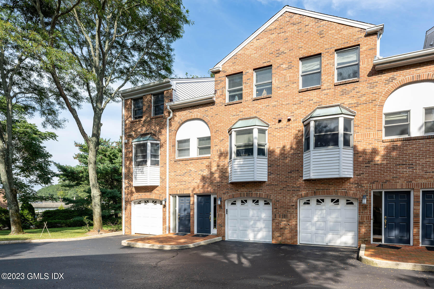 115 River Road, Unit 12 Cos Cob, CT 06807 - Photo 10 of 27 a front view of a house with glass windows
