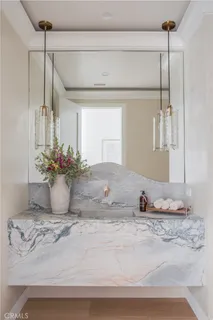 a bathroom with a granite countertop sink a mirror and shower