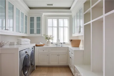a view of a kitchen with sink and washer dryer