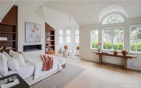 a spacious bedroom with a bed and a large window