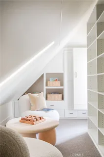 a living room with furniture and white walls