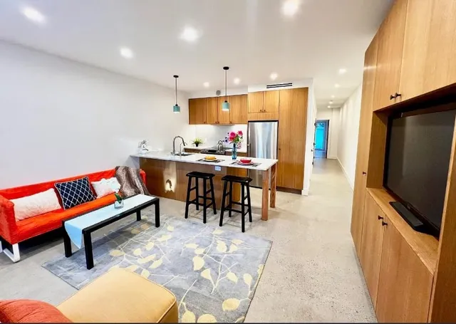 a living room with furniture a rug and a flat screen tv