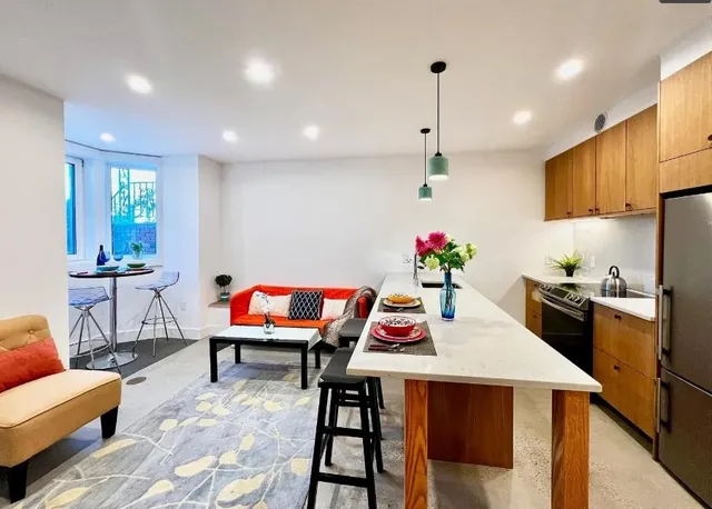 a living room with dining room and kitchen view