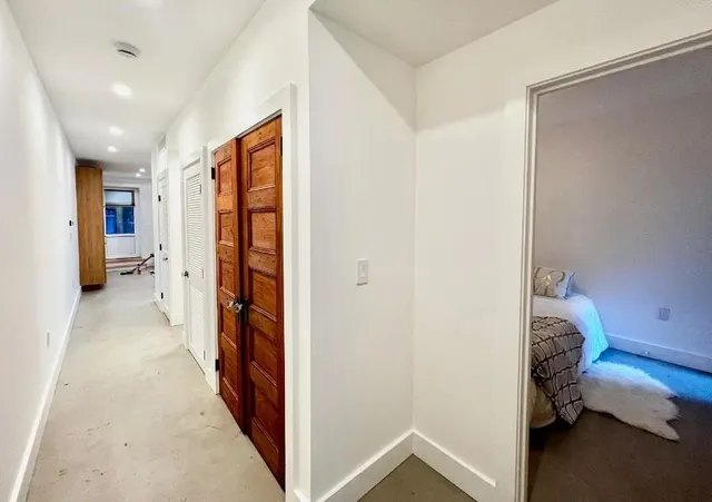 a view of a hallway with washer and dryer