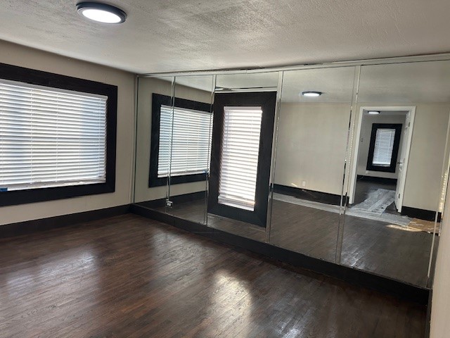 18943 Highway 7 Centerville, TX 75833 - Photo 17 of 33 an empty room with wooden floor and windows