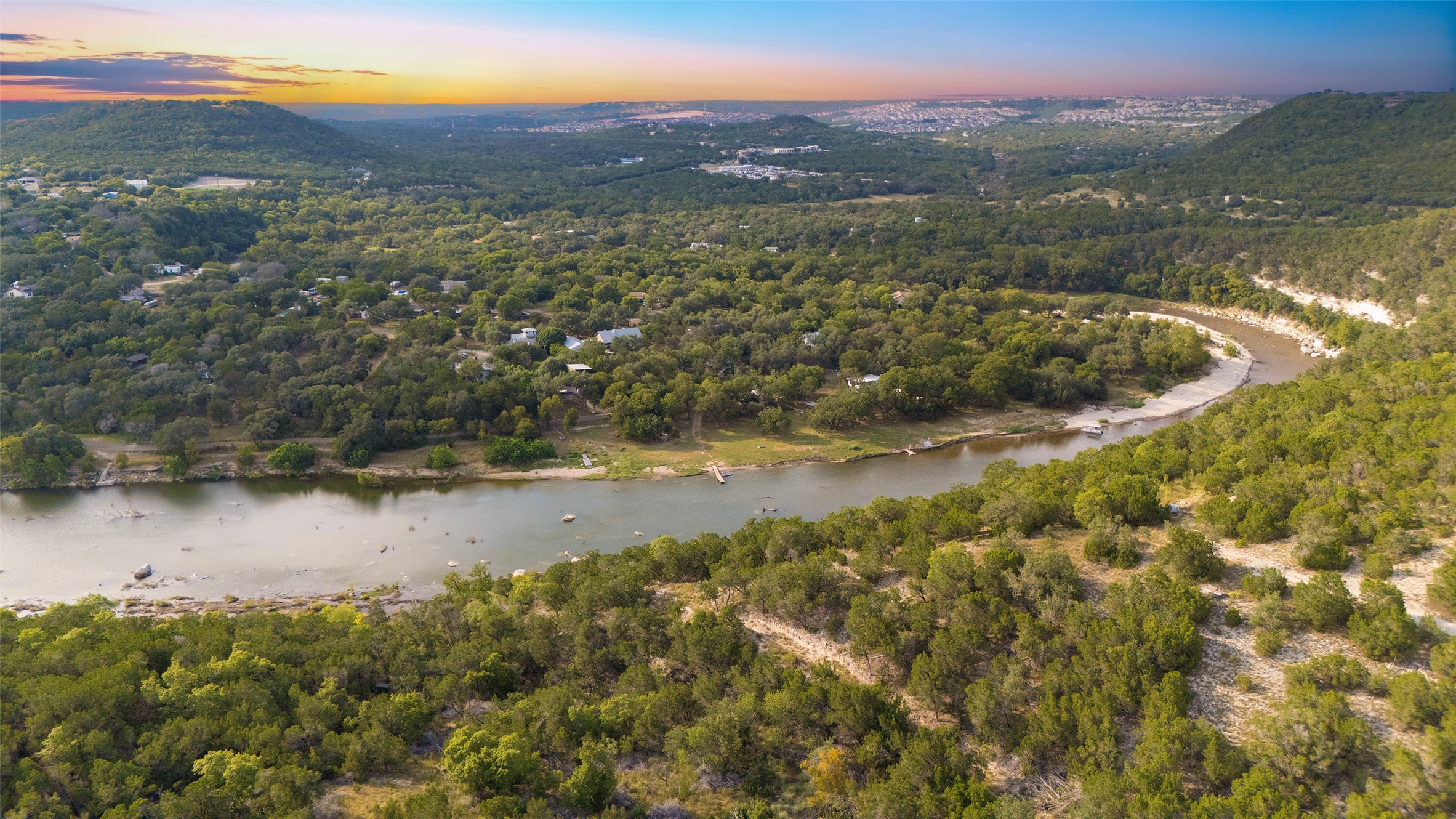 Aerial view at dusk of a wooded view and a water view