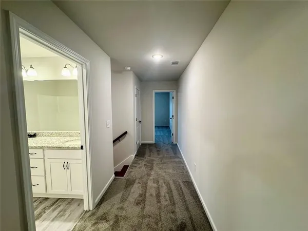a view of a hallway with wooden floor