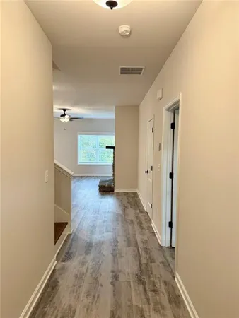 a view of hallway with wooden floor