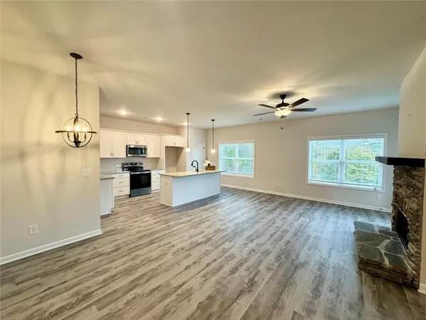 a view of a kitchen with a sink wooden floor and a window