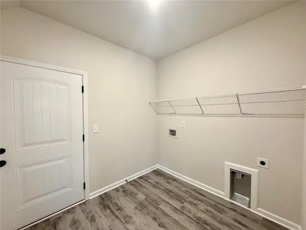a view of a room with wooden floor