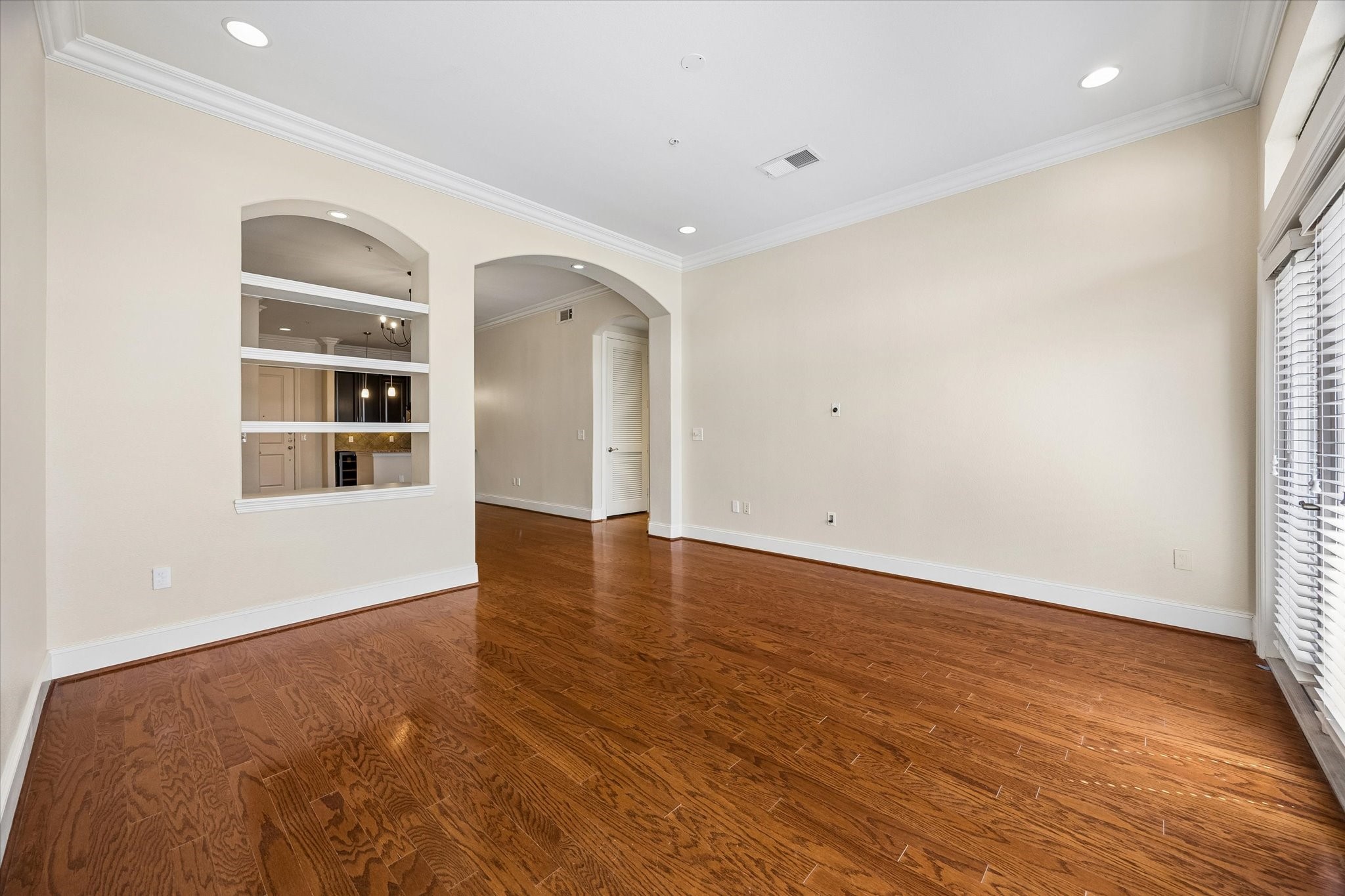 2120 Kipling Street, Unit 207 Houston, TX 77098 - Photo 2 of 35 Bookcase nook separates the living room and dining room while keeping it open
