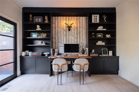 a living room with furniture a rug and a bookshelf