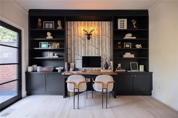a living room with furniture a rug and a bookshelf