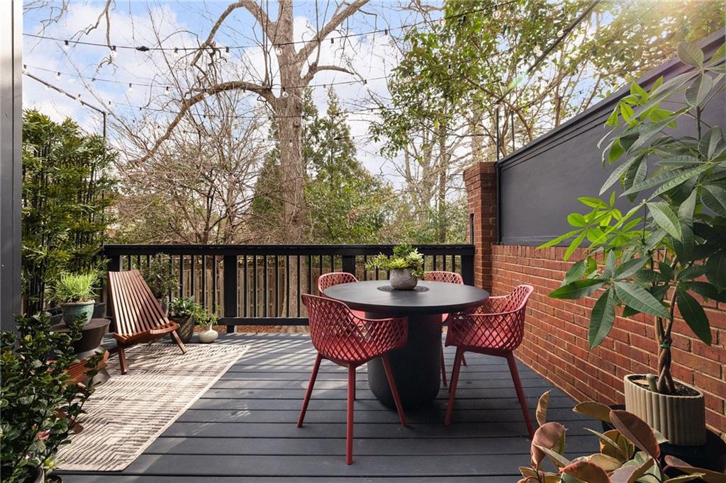 237 Sycamore Place Decatur, GA 30030 - Photo 14 of 52 a balcony with wooden floor table and chairs