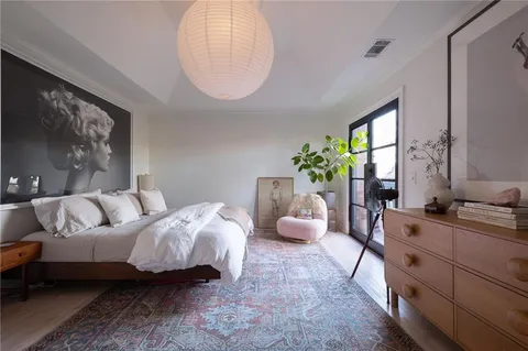 a bedroom with bed and a chair