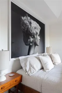 a view of living room with a floor to ceiling window and potted plant