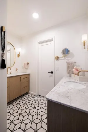 a white bath tub sitting next to a bathroom sink