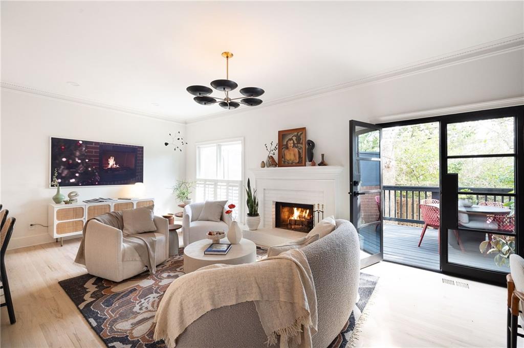 237 Sycamore Place Decatur, GA 30030 - Photo 4 of 52 a living room with furniture a fireplace and a flat screen tv