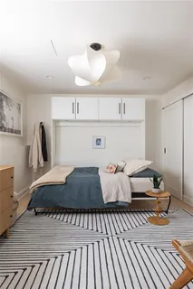a living room with furniture a rug and a window
