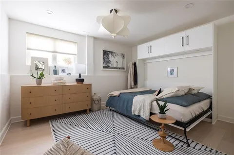 a spacious bathroom with a toilet a sink and mirror