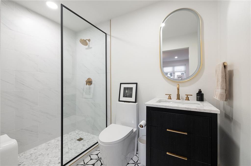237 Sycamore Place Decatur, GA 30030 - Photo 46 of 52 a bathroom with a double vanity sink toilet and shower