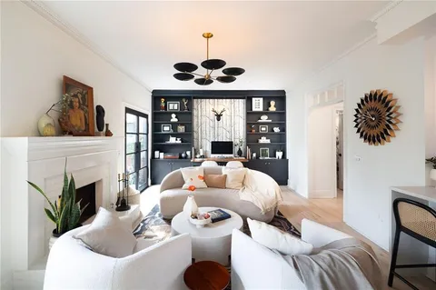 a living room with furniture fireplace and flat screen tv