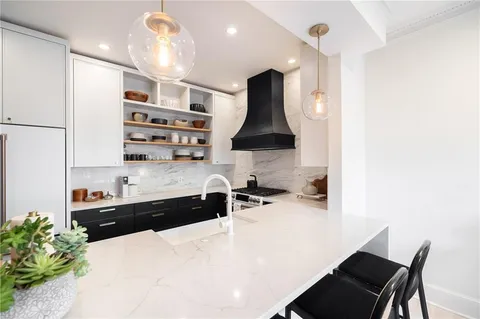 a kitchen with stainless steel appliances a sink and a stove