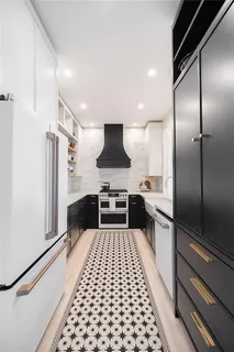 a kitchen with a sink and a refrigerator