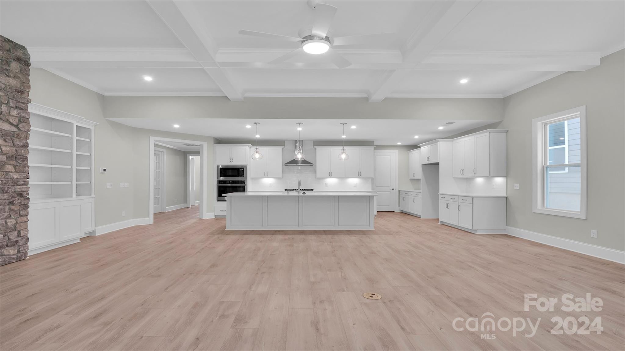 3053 Trace Meadow York, SC 29745 - Photo 18 of 28 a view of a kitchen with kitchen island a sink wooden floor and a refrigerator