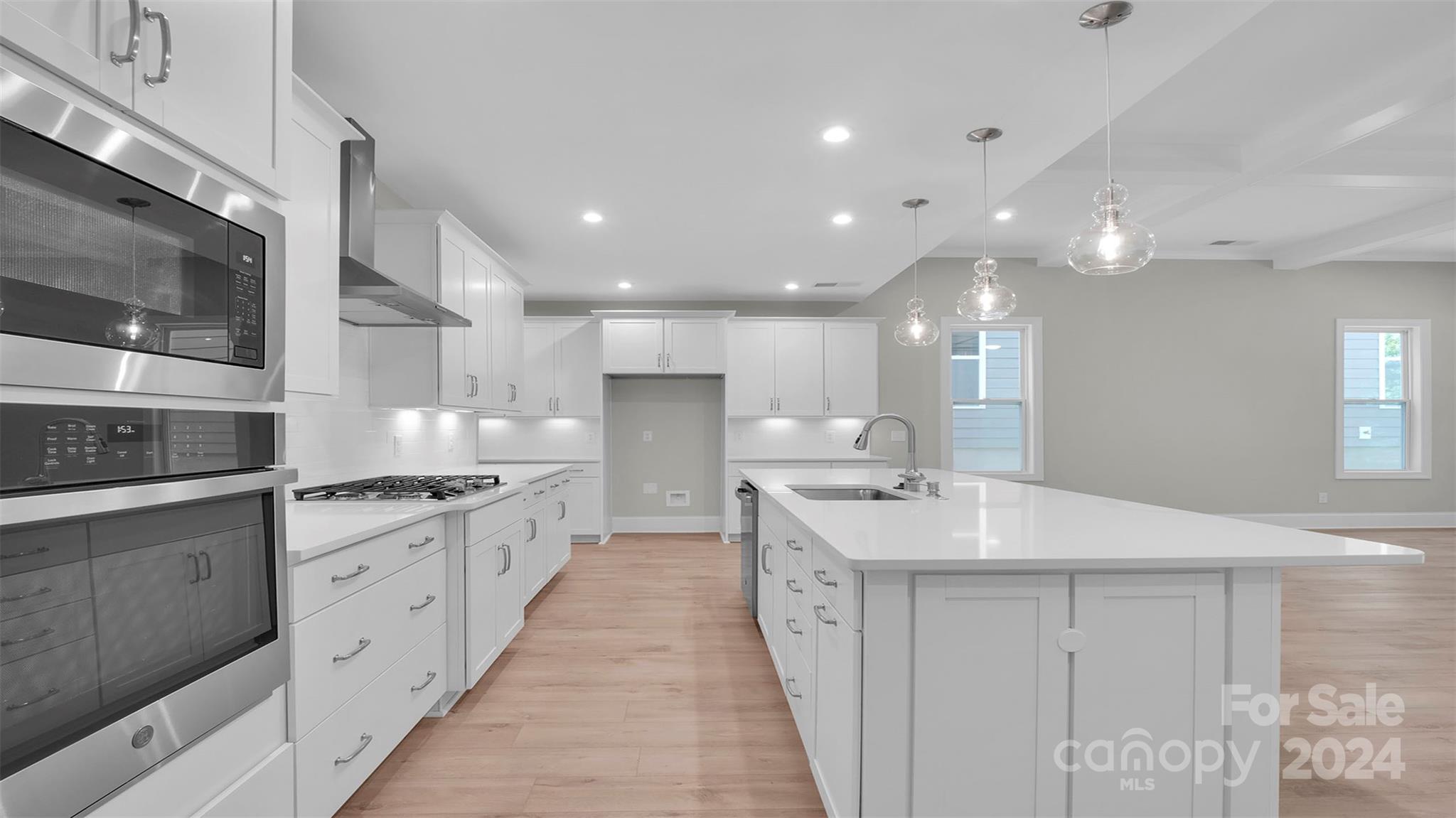 3053 Trace Meadow York, SC 29745 - Photo 3 of 28 a large white kitchen with a large kitchen island sink stainless steel appliances and cabinets