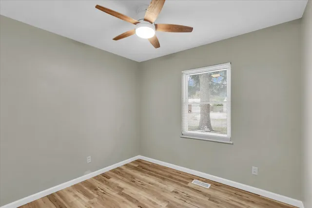 a view of room with window and ceiling fan