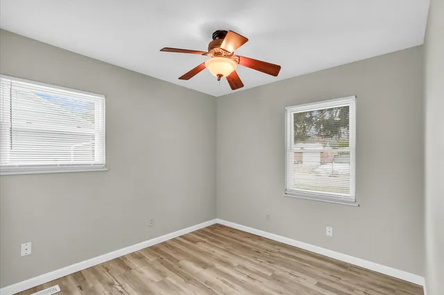wooden floor in an empty room with a window