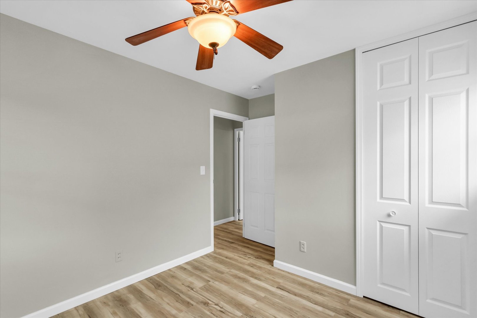 2808 Carrelton Drive Champaign, IL 61821 - Photo 17 of 24 an empty room with wooden floor and fan