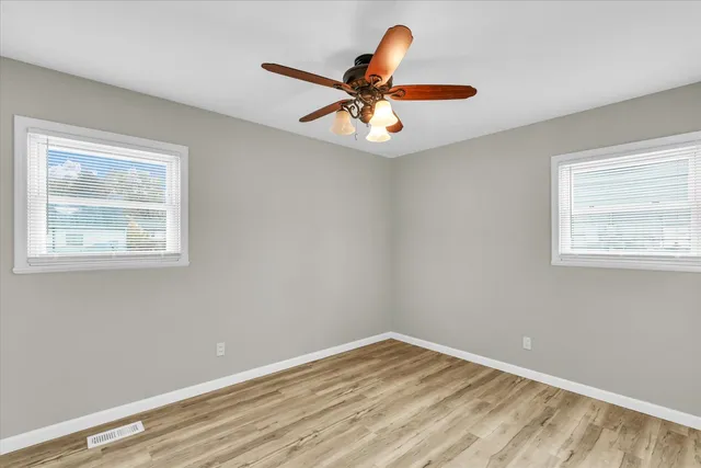 wooden floor in an empty room with a window