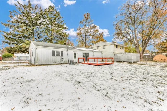 a view of a house with a yard and large tree