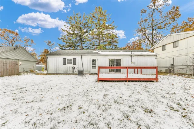 a white house with a large tree in front of it